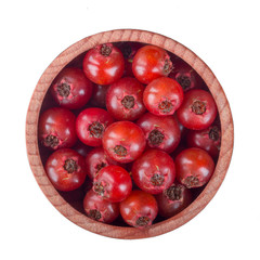 hawberries in wooden cup isolated on white background