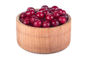 fresh red cowberry in wooden cup isolated on white background