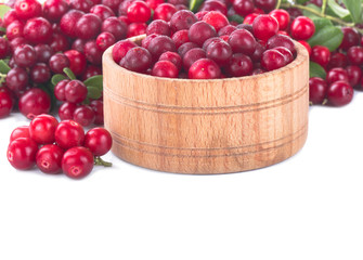 fresh red cowberry in wooden cup isolated on white background