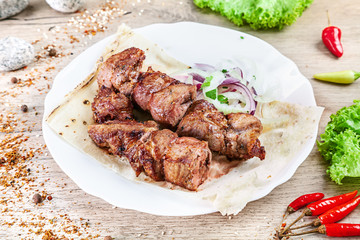Close up view on served cooked on the grill pork. shashlik or barbecue meat on pita. Shish kebab, traditional georgian cuisine food. Copy space for design