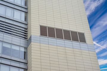 Wall of a modern office building with ventilation grilles for air conditioning