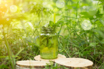 Lemonade or Mojito cocktail with lemon and mint, cold refreshing drink in the sun