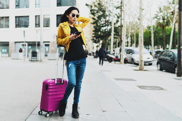 International student girl arrived at the university campus after summer vacation. Asian entrepreneur buying flight tickets for the business trip online using mobile phone internet connection.