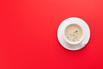 Coffee cup over red background