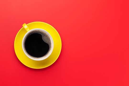 Yellow Coffee Cup Over Red Background