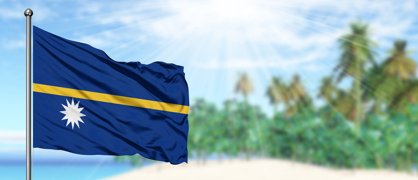 Waving Nauru Flag In The Sunny Blue Sky With Summer Beach Background. Vacation Theme, Holiday Concept.