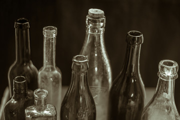 Collection of vintage bottles on dark blurred background. Close up
