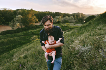 Father walking with infant baby outdoor family vacations lifestyle dad and child traveling together...