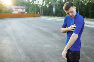 Young man in the blue sport jacket looking on the sleeve