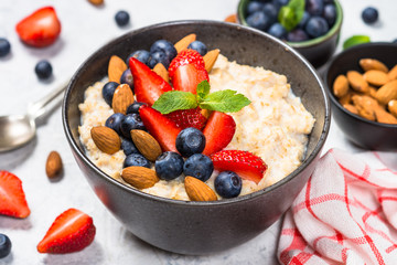 Oatmeal porridge with fresh berries and nuts. 