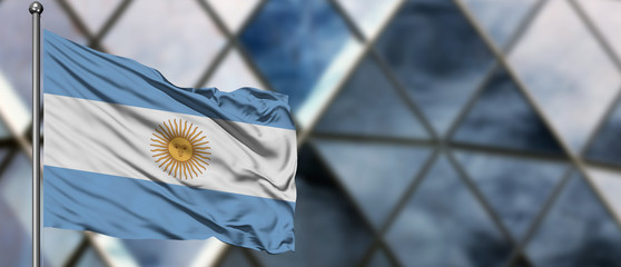 Argentina flag waving in the wind against blurred modern building. Business concept. National...