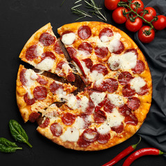 Hot Sliced Pepperoni Pizza On Black Table