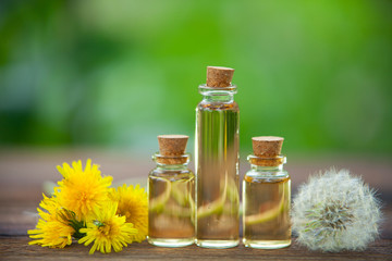 dandelion essential oil in  beautiful bottle on table © solstizia