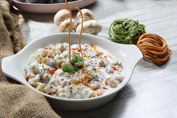 Plates of traditional Turkish food. Manti(Turkish ravioli) with tomato sauce