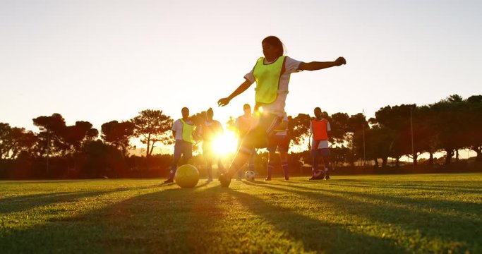 Female soccer player shooting the ball.
