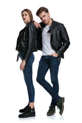 Determined punk couple posing while he is leaning on her