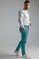 Unimpressed man stepping and looking over his shoulder