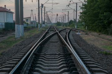 Fototapeta premium Rails close-up from a low angle, passing in the city