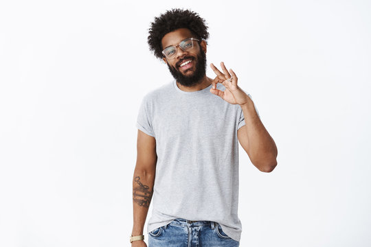 No worries, chill it okay. Portrait of carefree confident and assured handsome african american bearded man in glasses showing ok gesture as confirming plan perfect, agree and giving positive opinion