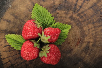 heap of strawberries on wooden background