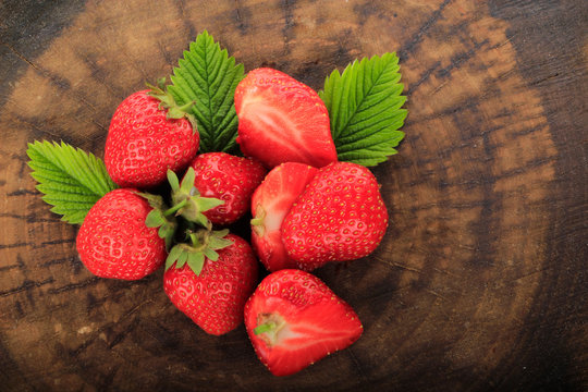 heap of strawberries on wooden background