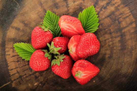 heap of strawberries on wooden background