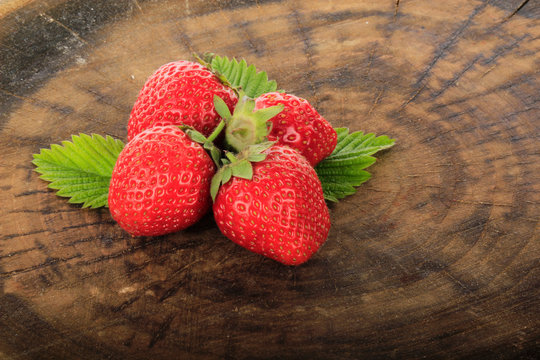 heap of strawberries on wooden background