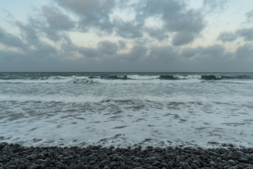 Waves on the beach and cloudy sky