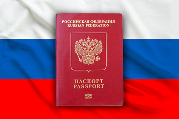 Russian Federation passport on the flag of the Russia, naturalization and immigration concept.