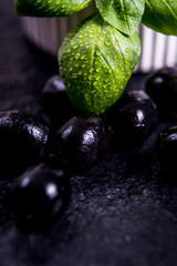 Black olives on black stone