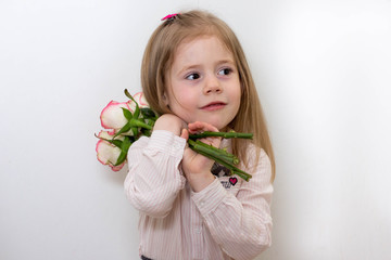 little girl with bouquet of red tulips