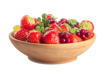strawberries and other berries in wooden plate isolated on white background