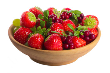 strawberries and other berries in wooden plate isolated on white background