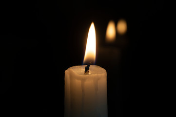 Close up of orange wax candle flame