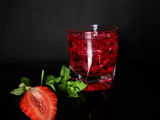 Strawberry, mint, ice, drink on a black background