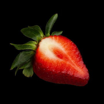 Half Of Strawberry Isolated On Black Background