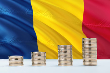 Chad flag waving in the background with rows of coins for finance and business concept. Saving...