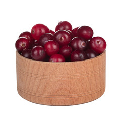 heap of fresh cranberries in wooden cup isolated