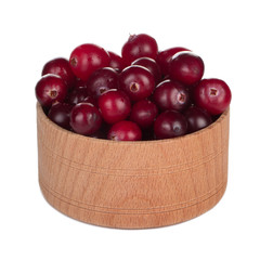 heap of fresh cranberries in wooden cup isolated