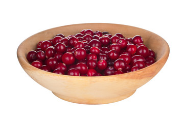 heap of fresh cranberries in wooden cup isolated