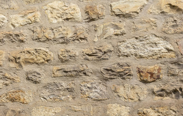 Old beige stones from an old stone wall