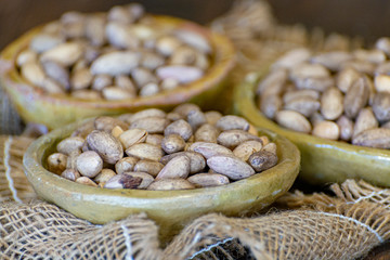 Clay bowls with dried pistachio nuts close up