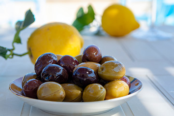 Italian green and black olives in olive oil close up