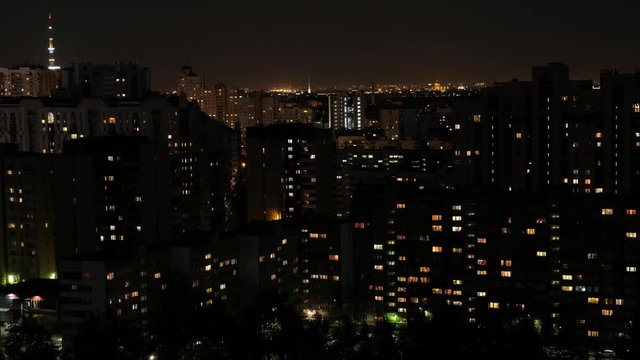 View of the night multi-storey houses. Lots of lights in the windows. Dormitory area.