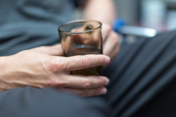 Man drinking tea in a glass cup, cozy atmosphere