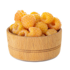heap of yellow raspberries in wooden cup isolated on white background