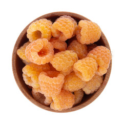 heap of yellow raspberries in wooden cup isolated on white background. top view