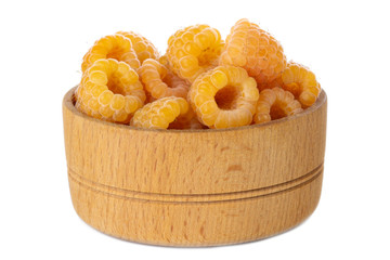 heap of yellow raspberries in wooden cup isolated on white background