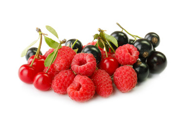 heap of red raspberries, cherry and black currants  isolated on white background