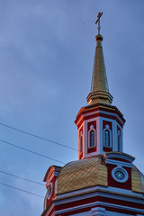 Golden dome with a cross on top evening sky background